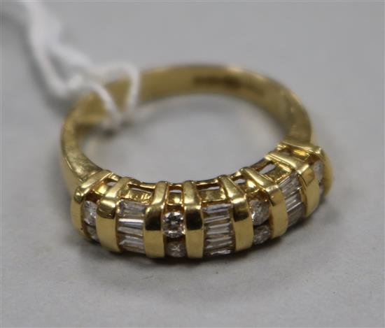 A modern 18ct gold, round and baguette cut diamond set half hoop ring, size M.